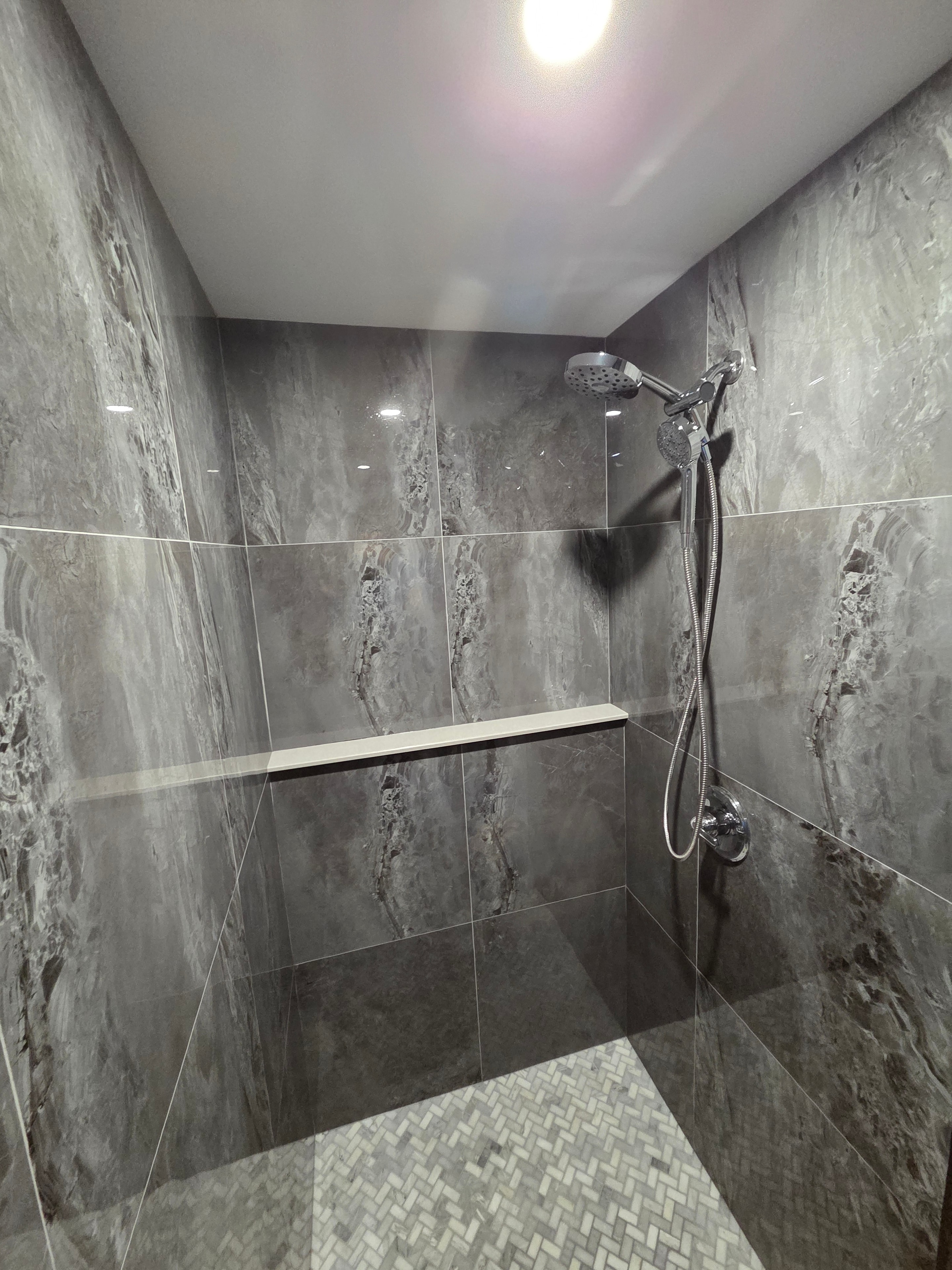 Custom marble tile shower with chrome fixtures